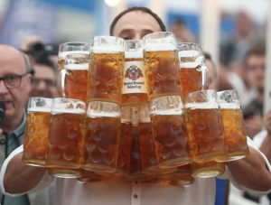 German man at oktoberfest holding steins